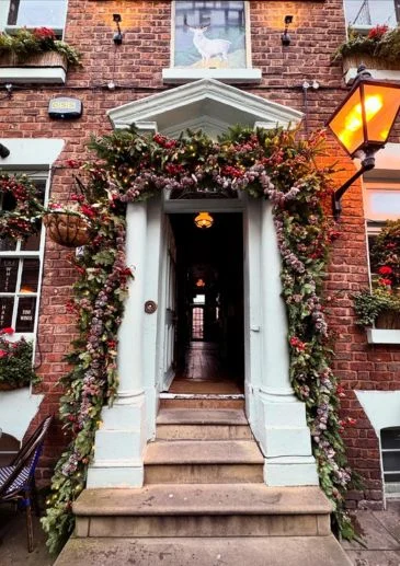Restaurants, Pubs & Bar decorated with a fresh greenery archway. Christmas Decorators Liverpool